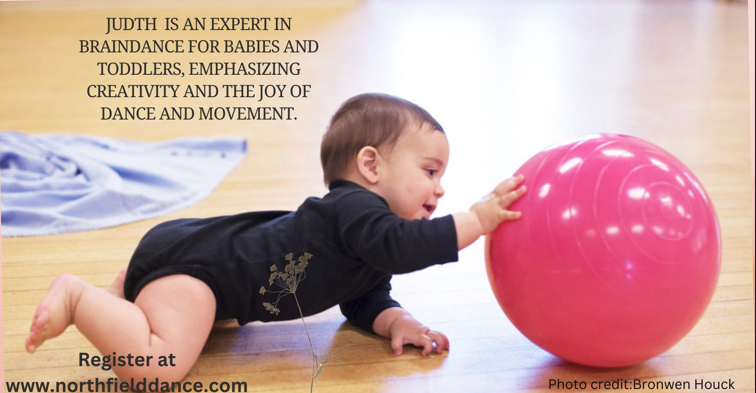 a baby reaches for a ball during Judith Nelson's baby braindance session